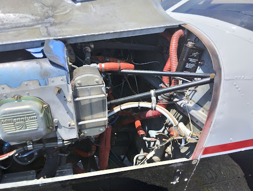 Engine view with wires, lines and brake fluid visible.